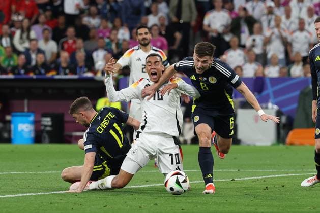 l r in duel, action, with Ryan Christie 11 Scotland , Jamal Musiala 10 Germany , Kieran Tierney 6 Scotland , Germany vs Scotland, Football, UEFA Euro 2024, Group stage, 1 Matchday, 14 06 2024 DFB regulations prohibit any use of photographs as image sequences and or quasi video Muenchen Bayern Germany Copyright: xkolbert-press ChristianxKolbertx