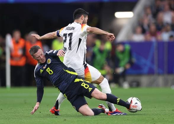 Munich, Germany, 14th June 2024.Callum McGregor of Scotland tackles Ilkay Gundogan of Germany during the UEFA European Championships match at Allianz Arena, Munich. Picture credit should read: David Klein Sportimage EDITORIAL USE ONLY. No use with unauthorised audio, video, data, fixture lists, club league logos or live services. Online in-match use limited to 120 images, no video emulation. No use in betting, games or single club league player publications. SPI-3194-0079