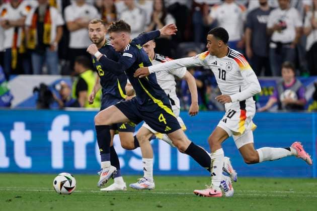 Germany v Scotland: Group A - UEFA EURO, EM, Europameisterschaft,Fussball 2024 Scott McTominay of Scotland and Jamal Musiala of Germany challenge during the UEFA EURO 2024 group stage match between Germany and Scotland at Munich Football Arena on June 14, 2024 in Munich, Germany. Munich Munich Football Arena Germany Germany Copyright: xRichardxSellers Sportsphoto APLx 14040498