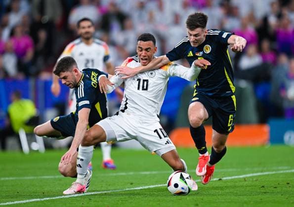 Ryan Christie Scotland , Jamal Musiala Germany and Kieran Tierney Scotland battle for the ball, UEFA EURO 2024 Group A, Germany vs Scotland, Munich Football Arena on June 14, 2024 in Munich, Germany Photo by Silas Schueller DeFodi Images Ryan Christie Scotland , Jamal Musiala Germany and Kieran Tierney Scotland battle for the ball, UEFA EURO 2024 Group A, Germany vs Scotland, Munich Football Arena on June 14, 2024 in Munich, Germany Photo by Silas Schueller DeFodi Images Defodi 0580986077st Defodi-738