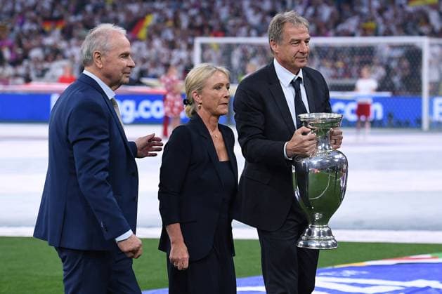 Soccer UEFA EURO 2024 group stage 1 match day opening match Germany Scotland on 14 06 2024 at the Munich Football Arena in Munich F l n r Bernard Dietz, Heidi Beckenbauer widow of Franz Beckenbauer , Jürgen Klinsmann with European Championship trophy trophy Henri Delaunay trophy xRx