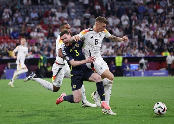 Munich, Germany, 14th June 2024. Andy Robertson of Scotland checked by Toni Kroos of Germany during the UEFA European Championships match at Allianz Arena, Munich. Picture credit should read: David Klein Sportimage EDITORIAL USE ONLY. No use with unauthorised audio, video, data, fixture lists, club league logos or live services. Online in-match use limited to 120 images, no video emulation. No use in betting, games or single club league player publications. SPI-3194-0104