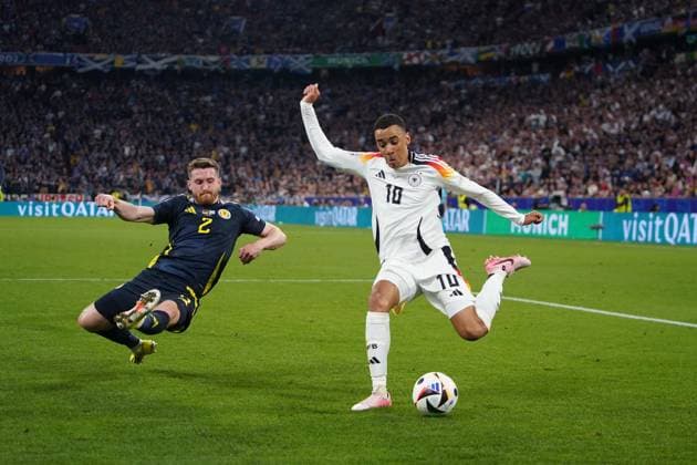 14 06 2024, Football UEFA EURO 2024, Preliminary round, Matchday 1, Opening match Germany Scotland, at the Fußball Arena München Jamal Musiala Germany wins against Anthony Ralston Scotland