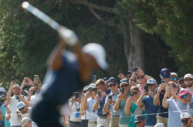 Spectators watch as Tiger Woods tees off on the thirteenth hole during the second round of the 124th U.S. Open golf championship at Pinehurst Resort & Country Club in Pinehurst, N.C. on Friday, June 14, 2024.  NCP20240614780 JOHNxANGELILLO
