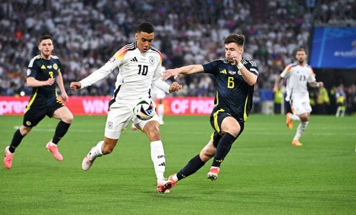 Football, European Championship, EURO 2024, Group A, Allianz Arena Munich Germany Scotland Jamal Musiala GER , Kieran Tierney SCO Action