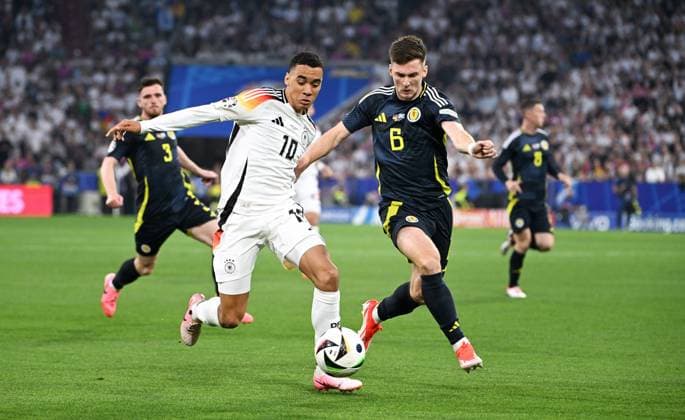 Football, European Championship, EURO 2024, Group A, Allianz Arena Munich Germany Scotland Jamal Musiala GER , Kieran Tierney SCO Action