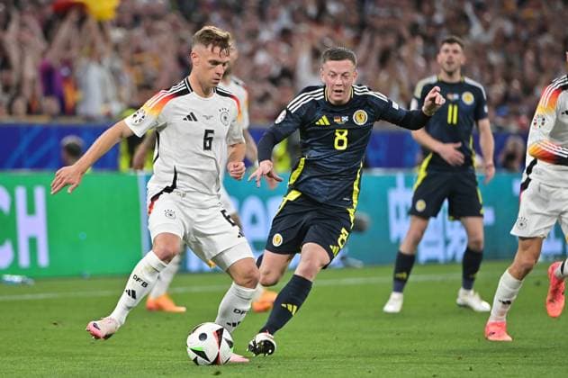 Picture shows from left to right Joshua Kimmich 6, Germany , Callum McGregor 8, Scotland , 14 06 2024, Munich, Football, European Championship, Germany Scotland, EVENT REGULATIONS PROHIBIT ANY USE OF PHOTOGRAPHS AS IMAGE SEQUENCES AND OR QUASI VIDEO xklx
