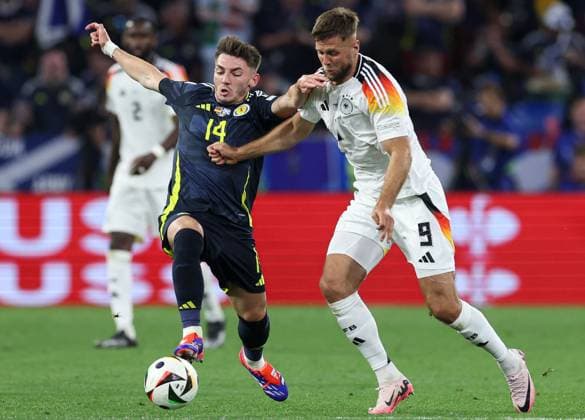 Billy Gilmour of Scotland (L) battles with Niclas Füllkrug of Germany (R) Germany v Scotland, UEFA European Championship, EM, Europameisterschaft 2024, Group A, Football, Munich Football Arena, Munich, Germany, 14 Jun 2024 EDITORIAL USE ONLY No use with unauthorised audio, video, data, fixture lists, club league logos or live services. Online in-match use limited to 120 images, no video emulation. No use in betting, games or single club league player publications.  Copyright: xPaulxCurrie Shutterstockx 14523776mb