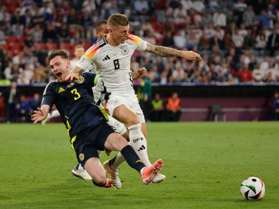 14 06 2024, European Football Championship, Germany vs Scotland, Allianz Arena Munich, Sport, in the picture Andrew Robertson Scotland vs Toni Kroos Germany , Jonathan Tah Germany