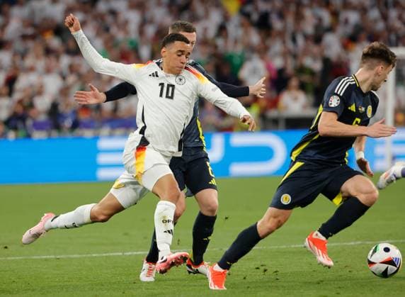 14 06 2024, European Football Championship, Germany vs Scotland, Allianz Arena Munich, Sport, in the picture Jamal Musiala Germany vs Callum McGregor Scotland