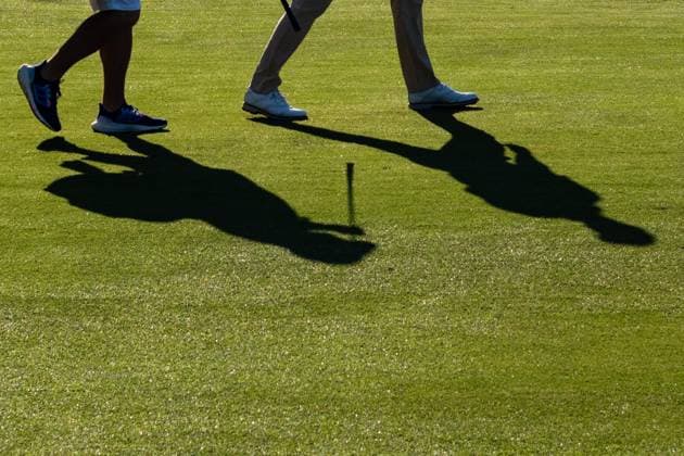 June 14, 2024, Pinehurst, North Carolina, USA: A player and caddie cast shadows on the 10th fairway during Friday s second round for the 124th U.S. Open, June 14, 2024, at Pinehurst Resort & Country Club (Course No. 2) in Pinehurst, North Carolina. Pinehurst USA - ZUMAh97_ 20240614_fap_h97_033 Copyright: xTimothyxL.xHalex