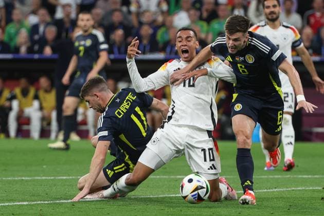 Euro 2024 Germany Scotland on 14 06 2024 at the Allianz Arena in Munich Jamal Musiala Germany 10 against Ryan Christie Scotland 11 and Kieran Tierney Scotland 6 MH