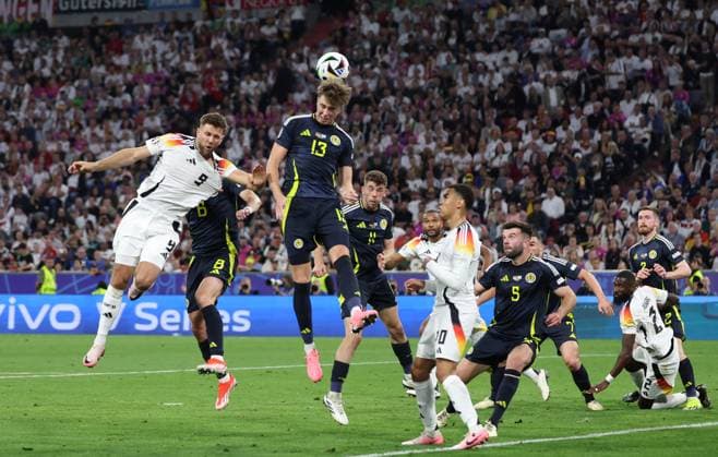 (240615) -- MUNICH, June 15, 2024 -- Jack Hendry (top) of Scotland vies for a header during the UEFA EURO, EM, Europameisterschaft,Fussball 2024 Group A match between Germany and Scotland in Munich, Germany on June 14, 2024. ) (SP)GERMANY-MUNICH-FOOTBALL-EURO 2024-GERMANY VS SCOTLAND BaixXuefei 