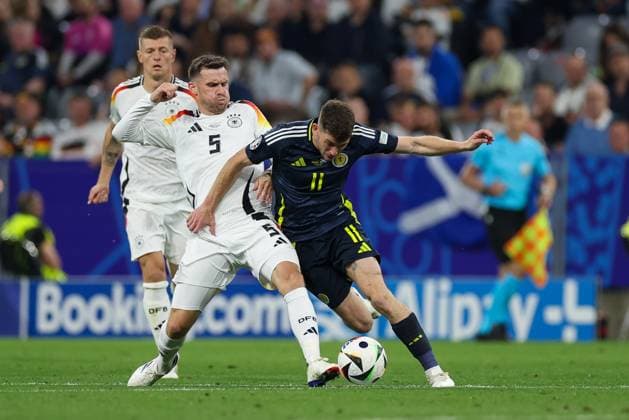 in duel, action, with Pascal Gross 5 Germany , Ryan Christie 11 Scotland , Germany vs Scotland, Football, UEFA Euro 2024, Group stage, 1 Matchday, 14 06 2024 DFB regulations prohibit any use of photographs as image sequences and or quasi video Muenchen Bayern Germany Copyright: xkolbert-press ChristianxKolbertx