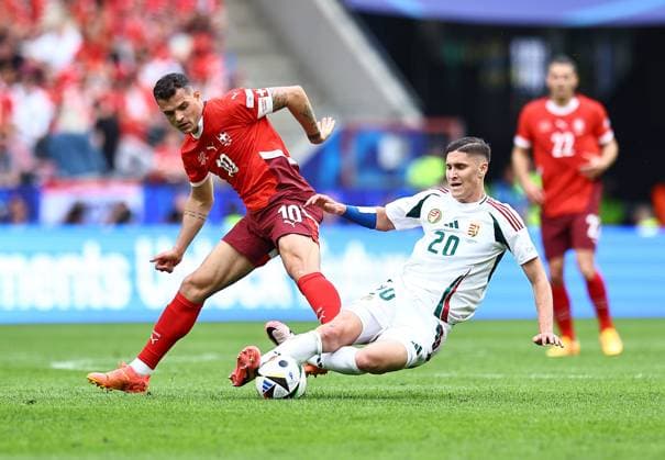 Granit Xhaka of Switzerland challenges with Roland Sallai of Hungary Hungary v Switzerland, UEFA European Championship, EM, Europameisterschaft 2024, Group A, Football, Cologne Stadium, Cologne, Germany, 15 Jun 2024 EDITORIAL USE ONLY No use with unauthorised audio, video, data, fixture lists, club league logos or live services. Online in-match use limited to 120 images, no video emulation. No use in betting, games or single club league player publications. Copyright: xMichaelxZemanek Shutterstockx 14539265ap