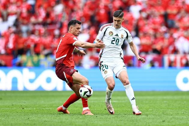 Granit Xhaka of Switzerland challenges with Roland Sallai of Hungary Hungary v Switzerland, UEFA European Championship, EM, Europameisterschaft 2024, Group A, Football, Cologne Stadium, Cologne, Germany, 15 Jun 2024 EDITORIAL USE ONLY No use with unauthorised audio, video, data, fixture lists, club league logos or live services. Online in-match use limited to 120 images, no video emulation. No use in betting, games or single club league player publications. Copyright: xMichaelxZemanek Shutterstockx 14539265ao