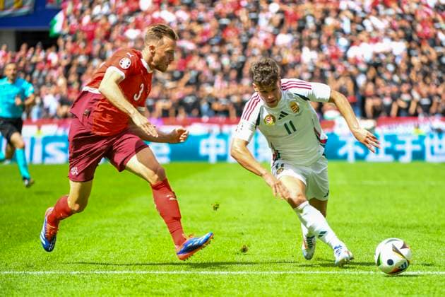 COLOGNE, GERMANY JUNE 15 Milos Kerkez of Hungary R against Silvan Widmer of Switzerland L during the UEFA EURO 2024 group stage match between Hungary and Switzerland at Cologne Stadium on June 15, 2024 in Cologne, Germany Cologne Cologne Stadium North Rhine Westphalia Germany Copyright: xJustPictures.ch ManuelxWinterbergerx jp-en-EuSpIm-MWI_7705