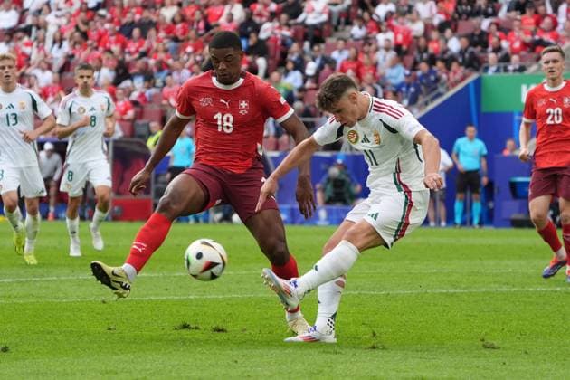 Milos Kerkez Hungary, Hungary, 11 clears in front of Kwadwo Duah Switzerland, Switzerland, Suisse, 18 Cologne 15 06 2024 Switzerland vs Hungary, EURO2024 M2, Group A, EM Arena Cologne