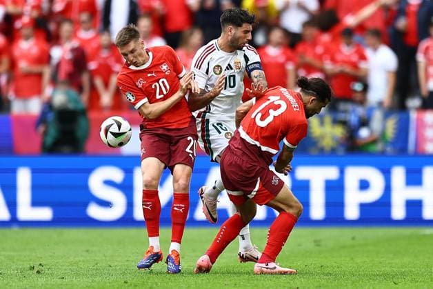 Dominik Szoboszlai of Hungary is challenged by Michel Aebischer of Switzerland and Ricardo Rodriguez of Switzerland Hungary v Switzerland, UEFA European Championship, EM, Europameisterschaft 2024, Group A, Football, Cologne Stadium, Cologne, Germany, 15 Jun 2024 EDITORIAL USE ONLY No use with unauthorised audio, video, data, fixture lists, club league logos or live services. Online in-match use limited to 120 images, no video emulation. No use in betting, games or single club league player publications.  Copyright: xMichaelxZemanek Shutterstockx 14539265bk