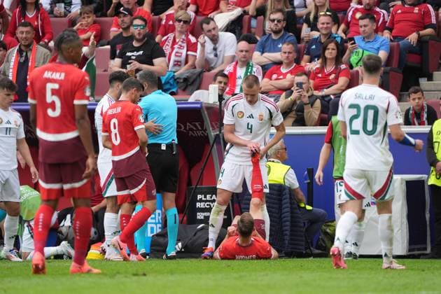 Fair play Attila Szalai Hungary, Hungary, 04 helps Silvan Widmer Switzerland, Switzerland, Suisse, 03 at Wadenkrampf Köln 15 06 2024 Switzerland vs Hungary, EURO2024 M2, Group A, EM Arena Köln
