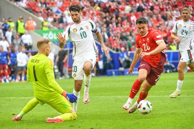COLOGNE, GERMANY JUNE 15 Fabian Rieder of Switzerland R against Dominik Szoboszlai of Hungary C and goalkeeper Peter Gulacsi of Hungary L during the UEFA EURO 2024 group stage match between Hungary and Switzerland at Cologne Stadium on June 15, 2024 in Cologne, Germany Cologne Cologne Stadium North Rhine Westphalia Germany Copyright: xJustPictures.ch ManuelxWinterbergerx jp-en-EuSpIm-MWI_7899