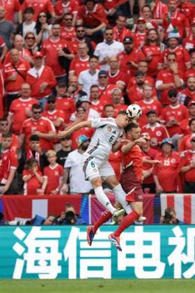 Cologne, Germany, 15th June 2024. Willi Orban of Hungary battles for an aerial ball with Silvan Widmer of Switzerland during the UEFA European Championships match at Cologne Stadium, Cologne. Picture credit should read: Jonathan Moscrop Sportimage EDITORIAL USE ONLY. No use with unauthorised audio, video, data, fixture lists, club league logos or live services. Online in-match use limited to 120 images, no video emulation. No use in betting, games or single club league player publications. SPI-3181-0035