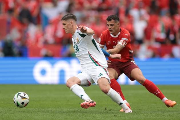 Cologne, Germany, 15th June 2024. Granit Xhaka of Switzerland tussles with Roland Sallai of Hungary during the UEFA European Championships match at Cologne Stadium, Cologne. Picture credit should read: Jonathan Moscrop Sportimage EDITORIAL USE ONLY. No use with unauthorised audio, video, data, fixture lists, club league logos or live services. Online in-match use limited to 120 images, no video emulation. No use in betting, games or single club league player publications. SPI-3181-0053