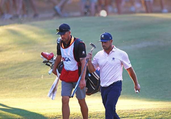 Bryson DeChambeau walks to the seventeenth green with his caddie during the third round of the 124th U.S. Open golf championship at Pinehurst Resort & Country Club in Pinehurst, N.C. on Saturday, June 15, 2024.  NCP20240615368 JOHNxANGELILLO
