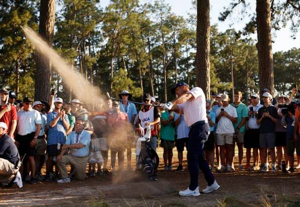 Bryson DeChambeau hits an approach shot to the fourteenth green during the third round of the 124th U.S. Open golf championship at Pinehurst Resort & Country Club in Pinehurst, N.C. on Saturday, June 15, 2024. DeChambeau finished the day in the lead at 7-under-par.  NCP20240615374 JOHNxANGELILLO