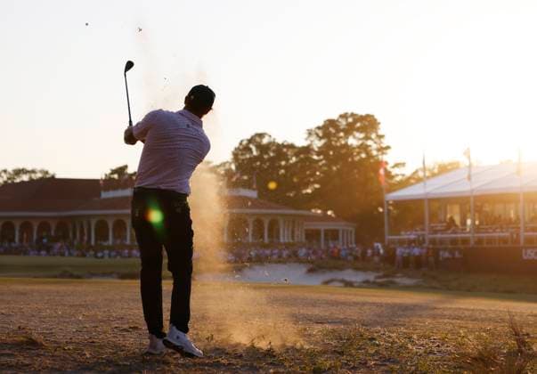 Bryson DeChambeau hits a pitch shot to the eighteenth green from the fairway during the third round of the 124th U.S. Open golf championship at Pinehurst Resort & Country Club in Pinehurst, N.C. on Saturday, June 15, 2024. DeChambeau finished the day in the lead at 7-under-par.  NCP20240615377 JOHNxANGELILLO