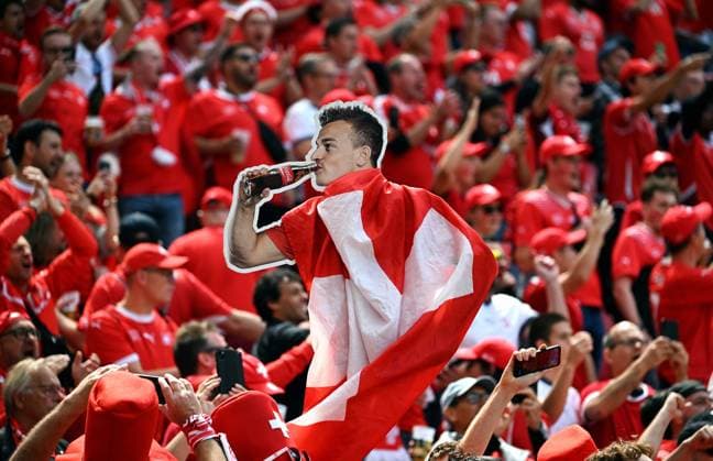 Football, European Championship, EURO 2024, Group A, Rhein Energie Stadium Cologne Hungary Switzerland 3 1 Swiss fans with advertising poster of Xherdan Shaqiri SUI fan, fans, fan culture, enthusiasm