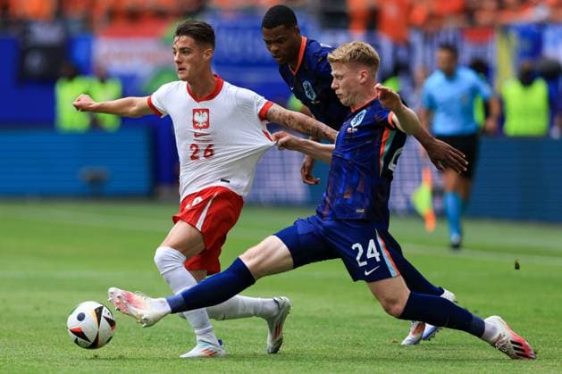 Kacper Urbanski of Poland is pulled back by Jerdy Schouten of The Netherlands Poland v Netherlands, UEFA European Championship, EM, Europameisterschaft 2024, Group D, Football, Volksparkstadion, Hamburg, Germany, 16 Jun 2024 EDITORIAL USE ONLY No use with unauthorised audio, video, data, fixture lists, club league logos or live services. Online in-match use limited to 120 images, no video emulation. No use in betting, games or single club league player publications.  Copyright: xMattxWest Shutterstockx 14539367by