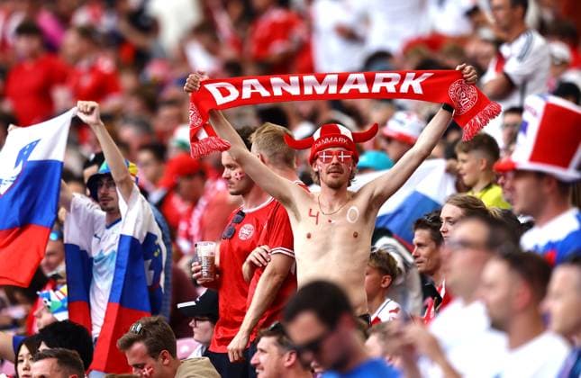 A denmark fan holds up a scarf ahead of the game Slovenia v Denmark, UEFA European Championship, EM, Europameisterschaft 2024, Group C, Football, Stuttgart Arena, Stuttgart, Germany, 16 Jun 2024 EDITORIAL USE ONLY No use with unauthorised audio, video, data, fixture lists, club league logos or live services. Online in-match use limited to 120 images, no video emulation. No use in betting, games or single club league player publications. Copyright: xMichaelxZemanek Shutterstockx 14539399ag