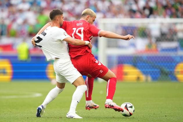 Denmark s Jonas Wind fight for the ball with Slovenia s Adam Gnezda Cerin during the Euro 2024 soccer match between Slovenia and Denmark at the Stuttgart Arena , Stuttgart , Germany - Sunday 16 , June , 2024. - Soccer .  Copyright: xSpada LaPressex