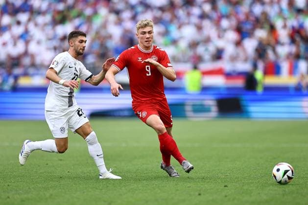 Rasmus Hojlund of Denmark passes the ball whilst being challenged by Adam Gnezda Cerin of Slovenia Slovenia v Denmark, UEFA European Championship, EM, Europameisterschaft 2024, Group C, Football, Stuttgart Arena, Stuttgart, Germany, 16 Jun 2024 EDITORIAL USE ONLY No use with unauthorised audio, video, data, fixture lists, club league logos or live services. Online in-match use limited to 120 images, no video emulation. No use in betting, games or single club league player publications. Copyright: xMichaelxZemanek Shutterstockx 14539399cm