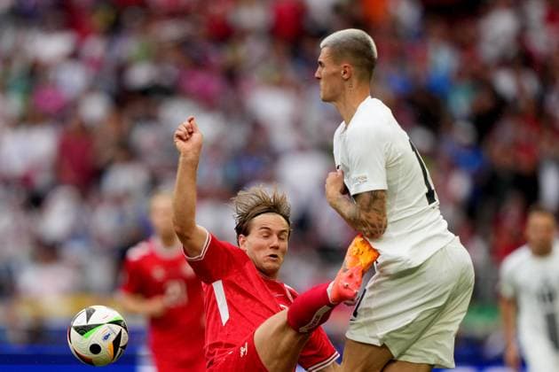 Slovenia s Benjamin Sesko fight for the ball with Denmark s Joachim Andersen during the Euro 2024 soccer match between Slovenia and Denmark at the Stuttgart Arena , Stuttgart , Germany - Sunday 16 , June , 2024. - Soccer .  Copyright: xSpada LaPressex