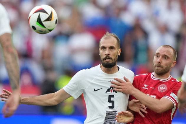 Slovenia s Jon Gorenc Stankovic fight for the ball with Denmark s Christian Eriksen during the Euro 2024 soccer match between Slovenia and Denmark at the Stuttgart Arena , Stuttgart , Germany - Sunday 16 , June , 2024. - Soccer .  Copyright: xSpada LaPressex