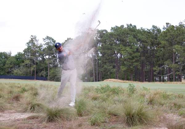 Bryson DeChambeau hits out of the rough on the eleventh hole during the final round of the 124th U.S. Open golf championship at Pinehurst Resort & Country Club in Pinehurst, N.C. on Sunday, June 16, 2024.  NCP20240616337 JOHNxANGELILLO