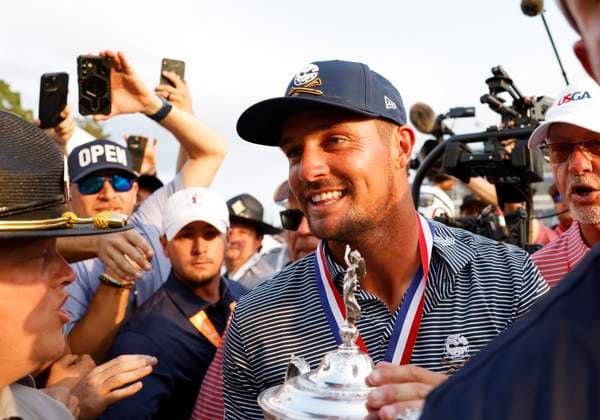 Bryson DeChambeau celebrates with fans holding the trophy after winning the 124th U.S. Open golf championship at Pinehurst Resort & Country Club in Pinehurst, N.C. on Sunday, June 16, 2024. DeChambeau won with a six-under-par score of 27.  NCP20240616902 JOHNxANGELILLO