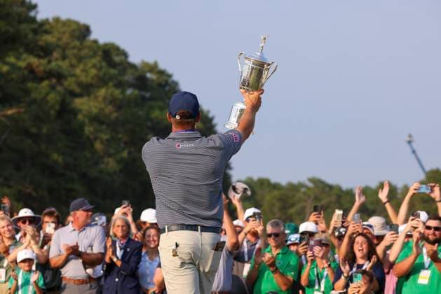 Bryson DeChambeau of the United States holds up the championship trophy after winning the 124th U.S. Open golf championship at Pinehurst Resort & Country Club in Pinehurst, N.C. on Sunday, June 16, 2024.  NCP20240616811 VeaseyxConway