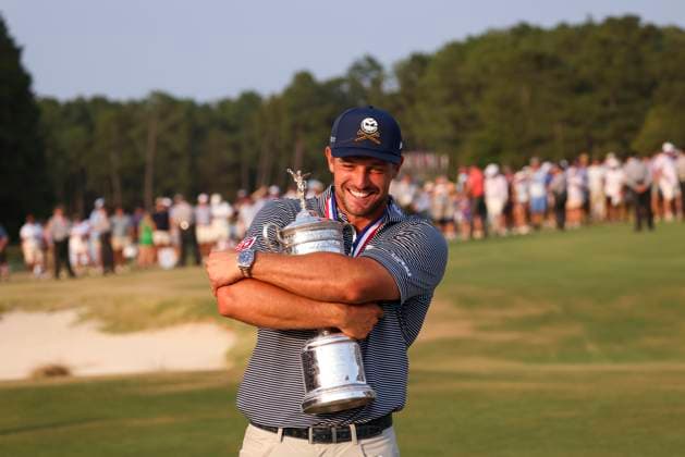Bryson DeChambeau of the United States hugs the championship trophy after winning the 124th U.S. Open golf championship at Pinehurst Resort & Country Club in Pinehurst, N.C. on Sunday, June 16, 2024.  NCP20240616812 VeaseyxConway