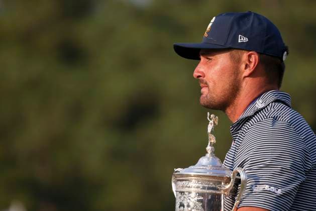 Bryson DeChambeau of the United States holds the championship trophy after winning the 124th US Open golf championship at Pinehurst Resort & Country Club in Pinehurst, N.C. on Sunday, June 16, 2024.  NCP20240616840 VeaseyxConway