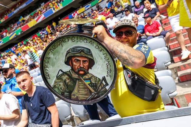 Soccer UEFA EURO 2024 group stage 1 match day Romania Ukraine on 17 06 2024 at Munich Football Arena in Munich Ukraine fan with drum on which is a drawing of a soldier xMSx