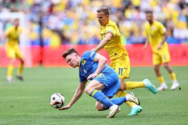 Viktor Tsyhankov of Ukraine is fouled by Nicuor Bancu of Romania Romania v Ukraine, UEFA European Championship, EM, Europameisterschaft 2024, Group E, Football, Munich Football Arena, Munich, Germany, 17 Jun 2024 EDITORIAL USE ONLY No use with unauthorised audio, video, data, fixture lists, club league logos or live services. Online in-match use limited to 120 images, no video emulation. No use in betting, games or single club league player publications. Copyright: xMichaelxZemanek Shutterstockx 14539636af
