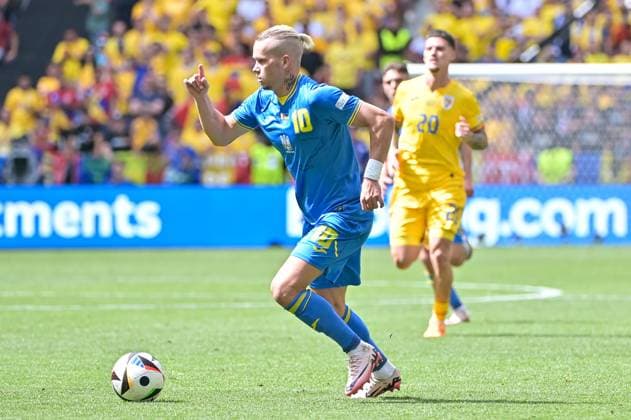 Picture shows Mudryk 10, Ukraine with ball on foot, Man 20, Romania , 17 06 2024, Munich, Soccer, European Championship, Romania Ukraine, EVENT REGULATIONS PROHIBIT ANY USE OF PHOTOGRAPHS AS IMAGE SEQUENCES AND OR QUASI VIDEO xklx