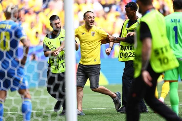 Romania fan is escorted from the pitch Romania v Ukraine, UEFA European Championship, EM, Europameisterschaft 2024, Group E, Football, Munich Football Arena, Munich, Germany, 17 Jun 2024 EDITORIAL USE ONLY No use with unauthorised audio, video, data, fixture lists, club league logos or live services. Online in-match use limited to 120 images, no video emulation. No use in betting, games or single club league player publications. Copyright: xMichaelxZemanek Shutterstockx 14539636bc