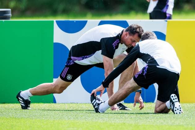 UEFA EURO 2024 final training Germany 18 06 2024 Michael Fuchs goalkeeper coach Germany and Andreas Kronenberg goalkeeper coach Germany stretch UEFA EURO 2024 final training Germany before the match against Hungary Herzobase, Herzogenaurach on 18 06 2024 Copyright: xBEAUTIFULxSPORTS Wunderlx