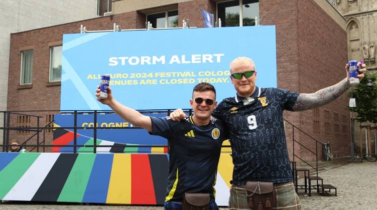 On a digital information board, the city of Cologne announces that the Euro 2024 fan festival will remain closed on Tuesday due to a severe weather warning These two fans of the Scottish national soccer team wont let it spoil their fun Cologne North Rhine-Westphalia