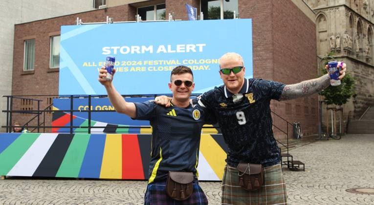 On a digital information board, the city of Cologne announces that the Euro 2024 fan festival will remain closed on Tuesday due to a severe weather warning These two fans of the Scottish national soccer team wont let it spoil their fun Cologne North Rhine-Westphalia