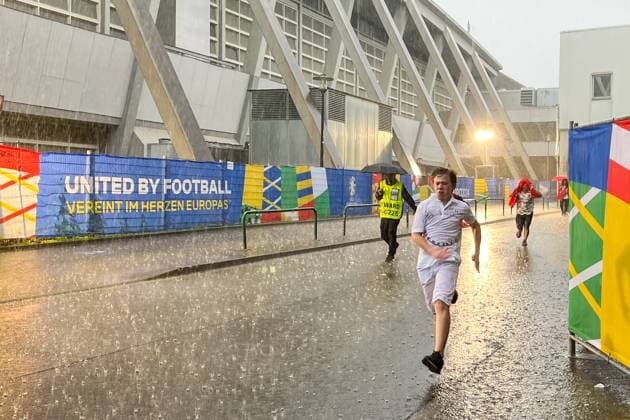 Turkish and Georgian fans flee from the rain under the entrance of the Westfalenhalle Dortmund 18 06 2024 Turkey vs Georgia, EURO2024 M11, Group F, EM Arena Dortmund
